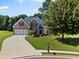 Charming two-story brick home with mature landscaping and a paved driveway at 7198 Golfside Se Dr, Covington, GA 30014