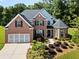 Beautiful brick home with a well-manicured lawn and an attached two-car garage at 7198 Golfside Se Dr, Covington, GA 30014