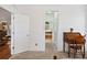 Hallway featuring a wooden desk and chair leads to a bathroom with a soaking tub at 7198 Golfside Se Dr, Covington, GA 30014