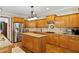 Spacious kitchen features stainless steel appliances, granite countertops, and a center island at 7198 Golfside Se Dr, Covington, GA 30014