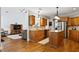 Open kitchen with granite countertops, stainless steel appliances, and hardwood floors at 7198 Golfside Se Dr, Covington, GA 30014