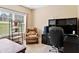 Office space featuring a comfortable chair, desk, shelving unit, and a bright window at 7198 Golfside Se Dr, Covington, GA 30014