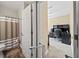 View into office space with desk and shelving, adjacent to bathroom with striped shower curtain at 7198 Golfside Se Dr, Covington, GA 30014