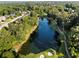Aerial view of a beautiful pond and sand traps on a golf course surrounded by lush greenery and community homes at 7198 Golfside Se Dr, Covington, GA 30014