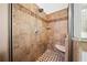 Glass enclosed tiled shower features a built in bench, tiled floor, and rainfall shower head at 7198 Golfside Se Dr, Covington, GA 30014