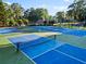 Well-maintained tennis courts with blue and green surfacing, perfect for recreational play at 7198 Golfside Se Dr, Covington, GA 30014