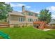 Exterior back view features a spacious backyard with a deck, patio and lush lawn at 2241 Chaseford Ln, Powder Springs, GA 30127