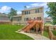 Exterior back view features a spacious backyard with a deck, patio and lush lawn at 2241 Chaseford Ln, Powder Springs, GA 30127
