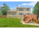 Exterior back view features a spacious backyard with a deck, patio and lush lawn at 2241 Chaseford Ln, Powder Springs, GA 30127