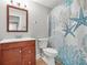 Bathroom featuring a wooden vanity, mirror, and ocean themed shower curtain at 2241 Chaseford Ln, Powder Springs, GA 30127