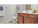 Bright bathroom featuring a wooden vanity, white countertop, and decorative accents at 2241 Chaseford Ln, Powder Springs, GA 30127