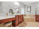 This bathroom features dual sinks, a soaking tub, and updated fixtures at 2241 Chaseford Ln, Powder Springs, GA 30127