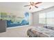 The bedroom showcases a vibrant dinosaur mural, twin beds, and ample natural light at 2241 Chaseford Ln, Powder Springs, GA 30127