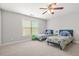 Bright bedroom with twin beds, neutral walls, and a ceiling fan at 2241 Chaseford Ln, Powder Springs, GA 30127