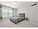 Cozy bedroom with a patterned bed, window, and playful decorations at 2241 Chaseford Ln, Powder Springs, GA 30127