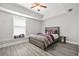 A cozy bedroom with tray ceilings, a window seat, and modern decor at 2241 Chaseford Ln, Powder Springs, GA 30127