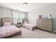 Charming bedroom featuring two twin beds, a dresser, and whimsical decor at 2241 Chaseford Ln, Powder Springs, GA 30127