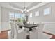 Large dining room featuring a modern chandelier and lots of natural light from surrounding windows at 2241 Chaseford Ln, Powder Springs, GA 30127