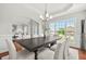 Elegant dining room with a tray ceiling, large windows, and a stylish chandelier above the table at 2241 Chaseford Ln, Powder Springs, GA 30127