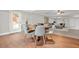 A dining room area with wooden table and views into the living room at 2241 Chaseford Ln, Powder Springs, GA 30127