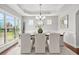 Spacious dining room with large windows, tray ceiling and modern chandelier at 2241 Chaseford Ln, Powder Springs, GA 30127