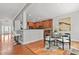 Open-concept dining area with a kitchen bar, hardwood floors, and stylish decor at 2241 Chaseford Ln, Powder Springs, GA 30127
