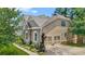 Exterior side view showcasing brick and siding, a two-car garage, and mature landscaping at 2241 Chaseford Ln, Powder Springs, GA 30127