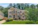 Charming two-story brick and stone home with well-manicured lawn and lush landscaping at 2241 Chaseford Ln, Powder Springs, GA 30127