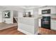 The kitchen area features black appliances, white cabinets, and a breakfast bar at 2241 Chaseford Ln, Powder Springs, GA 30127