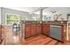 Open kitchen featuring granite countertops, stainless steel dishwasher, and hardwood flooring at 2241 Chaseford Ln, Powder Springs, GA 30127