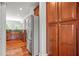 Modern kitchen features stainless steel refrigerator, wooden cabinetry and granite countertops at 2241 Chaseford Ln, Powder Springs, GA 30127