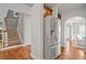 Hallway view of kitchen with stainless steel refrigerator and stairs leading to upper level at 2241 Chaseford Ln, Powder Springs, GA 30127
