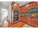 Well-equipped kitchen boasts stainless steel appliances, double oven, and wood cabinets for a functional space at 2241 Chaseford Ln, Powder Springs, GA 30127