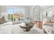 Cozy living area bathed in natural light, showcasing modern decor and an open layout to the dining area at 2241 Chaseford Ln, Powder Springs, GA 30127