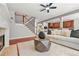 Cozy living room featuring hardwood floors, fireplace, staircase, and seamless flow to kitchen at 2241 Chaseford Ln, Powder Springs, GA 30127