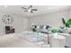 Comfortable living room with a ceiling fan, modern furniture, and large area rug at 2241 Chaseford Ln, Powder Springs, GA 30127
