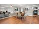 A cozy living room featuring a grey sofa, entertainment center, and combined kitchen and dining area at 2241 Chaseford Ln, Powder Springs, GA 30127