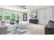 Spacious living room with modern furniture, large windows, and a ceiling fan at 2241 Chaseford Ln, Powder Springs, GA 30127