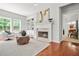 Bright living room featuring a fireplace, built-in shelving, and hardwood floors at 2241 Chaseford Ln, Powder Springs, GA 30127