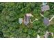 Aerial view of wooded lot with lush landscaping, private pool, long driveway, and beautiful home at 140 Silvermere, Fayetteville, GA 30215