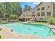 Backyard with an inviting pool, deck, and lush greenery, creating a private and relaxing outdoor oasis at 140 Silvermere, Fayetteville, GA 30215