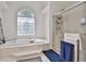 Bathroom showing a soaking tub with decorative window, and walk-in shower at 140 Silvermere, Fayetteville, GA 30215