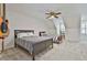 Bedroom featuring two beds with ceiling fan and decor, ideal for guests or a shared bedroom at 140 Silvermere, Fayetteville, GA 30215