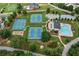 Aerial view showcases community amenities: swimming pool, clubhouse, and multiple tennis courts at 140 Silvermere, Fayetteville, GA 30215