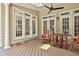 Inviting covered deck with natural wood floors and pillars with french doors leading inside the home at 140 Silvermere, Fayetteville, GA 30215