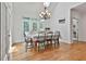 Elegant dining room filled with natural light, vaulted ceilings, and a classic chandelier at 140 Silvermere, Fayetteville, GA 30215