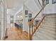 Inviting entryway featuring hardwood floors, stairs and a glimpse of the modern kitchen with a breakfast bar at 140 Silvermere, Fayetteville, GA 30215