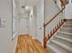A hallway features hardwood floors and a carpeted staircase leading to the upper level at 140 Silvermere, Fayetteville, GA 30215