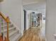 The carpeted stairs lead to a hallway featuring hardwood floors and a custom bookshelf at 140 Silvermere, Fayetteville, GA 30215