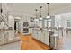Gourmet kitchen with stainless steel appliances, granite counters, white cabinetry, and center island at 140 Silvermere, Fayetteville, GA 30215